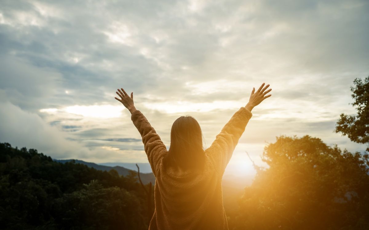 Happy woman with sunset in nature